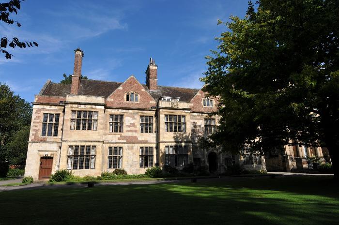 Exterior of the medieval Kings Manor building in York, now part of University of York, taken on a sunny day with a blue sky and a large tree in leaf in the right hand side of the image. Image copyright: Paul Shields, University of York photographer.